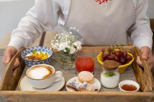 a person holding a tray with a tray of breakfast foods at Relais Valle Dell'Idro in Otranto