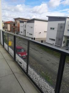 un balcone con recinzione e auto rossa di AURORA suites a Ghiroda