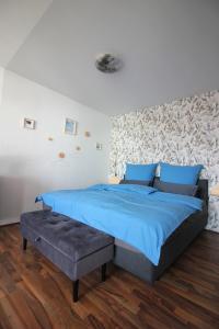 a bedroom with a bed with blue sheets and blue pillows at Blaues Paradies in Bad Rodach