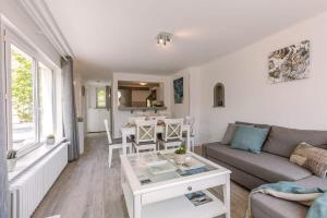 a living room with a couch and a table at Charming beachside villa with private terrace in Knokke-Heist