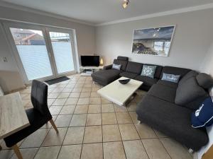 a living room with a couch and a table at Fehmarn 17-7 in Fehmarn