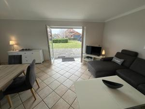 a living room with a couch and a table at Fehmarn 17-7 in Fehmarn