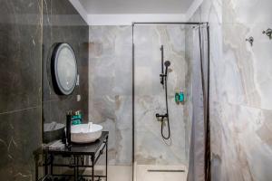 a bathroom with a shower and a sink at Hotel Forty One in Bucharest