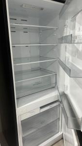 an empty refrigerator with its door open and its shelves at Ground Floor Unit Near Liverpool in Mount Pritchard