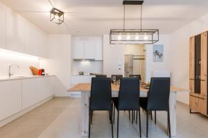 een keuken en eetkamer met een tafel en stoelen bij Bright apartment only 5 minutes from the beach in Middelkerke