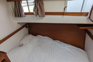 a small bed in a small room with a window at Au coeur de Cannes - Le Brise Iodée in Cannes