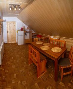 a dining room with a table and chairs and a refrigerator at Carynka in Ustrzyki Górne