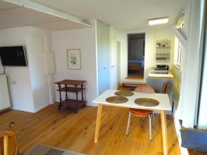 a kitchen and dining room with a table and chairs at Stilvolle Ferienwohnung in Rheinfelden in Nollingen