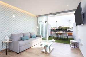 a living room with a couch and a table at Sunnyland apartment ten-bel in Arona