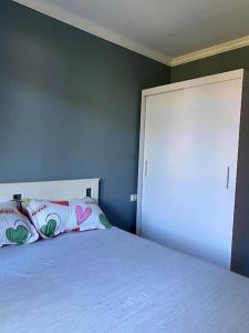 a bedroom with a white bed and a blue wall at Santa Marina, Lovely 1-bedroom apartment in Sozopol +28 photos