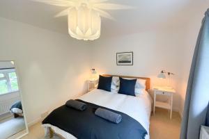 a bedroom with a large bed and a mirror at Sole Bay Croyde in Croyde