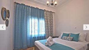 a bedroom with a bed with towels on it at Cosy Colorful House with Private Parking in Kavála