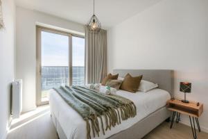 Ένα ή περισσότερα κρεβάτια σε δωμάτιο στο Huswell - Modern apartment with south facing terrace