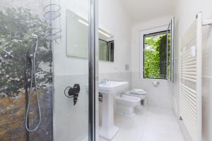 a bathroom with a toilet and a sink and a shower at Living UniQC Apartment - Duomo in Milan