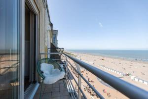 a balcony with a view of the beach at Cosy apartment with frontal seaview in Nieuwpoort