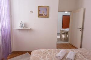 a bedroom with a bed with two towels on it at center_apartment_LUX in Podgorica