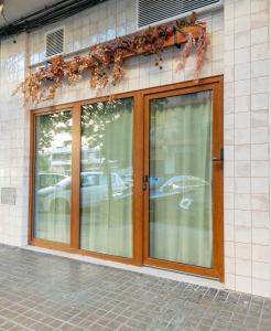 a store front with glass doors on a building at Apartamento bosque encantado HM13 in Valencia
