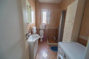 a small bathroom with a toilet and a sink at center_apartment_LUX in Podgorica