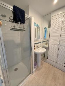 a bathroom with a shower and a sink at Downs Gate Cottage in Eastbourne