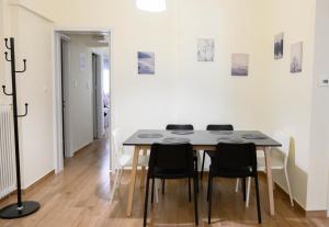 a dining room with a table and chairs at Stella’s Minimal Lodge in Tríkala