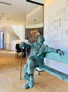 a statue of a man sitting on a bench at Boutique Hotel Villa Salvador - Adults Only by Fimedhotels in Cadaqués