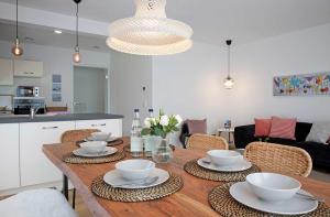 a dining room table with bowls and plates on it at Ferienhaus Moos in Wasserburg am Bodensee