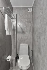 a bathroom with a white toilet in a room at Chic, Modern Seaside Oasis in Sunny Piraeus! in Piraeus