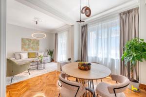 a living room with a table and chairs at Contemporary 2-BDR APT near Kalimarmaro & Alsos Park! in Athens