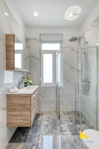 a bathroom with a shower and a sink at Contemporary 2-BDR APT near Kalimarmaro & Alsos Park! in Athens