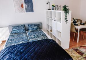 a bedroom with a bed and a white shelf at Cosy apartment Zugló next to Puskás Aréna in Budapest