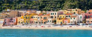 a group of buildings on a beach next to the water at Albatros in Savona