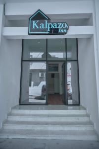 a building with a sign on the front of it at Kalpazo Inn Tirana in Tirana