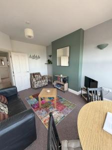 a living room with a couch and a table at Seabreeze Apartment in Eastbourne