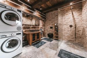 a laundry room with a washer and dryer at Roubenka50 in Jičín