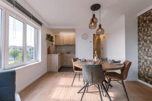 a kitchen and dining room with a table and chairs at Huswell - Cosy apartment with vintage interior in De Haan +16 photos