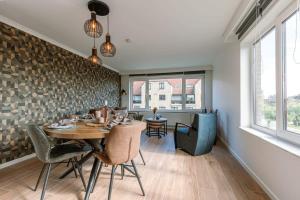a dining room with a table and chairs at Cosy apartment with vintage interior in De Haan