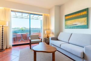 a living room with a couch and a table at Puerto Antilla Grand Hotel in Islantilla