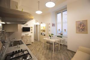 a kitchen with a sink and a table with a tableablish at La Regina di Spaccanapoli in Naples