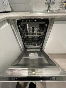 a dishwasher with the door open in a kitchen at Stylish 2 bedroom Apartment in Kettering in Northampton