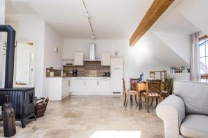 a kitchen and dining room with a couch and a table at Hofgut Dösterhof - Ferienwohnungen in Wadern