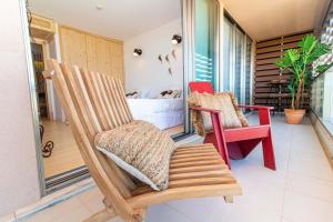 um alpendre com duas cadeiras de baloiço e uma cama em Apartment Terracota By Dalma Portuguesa na Galé