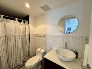 a bathroom with a toilet and a sink and a mirror at Apartment with perfect city view in Guatemala
