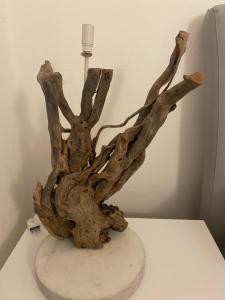 a tree branch sculpture sitting on a white table at La bella vista in Sestri Levante