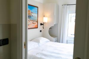 a bedroom with a bed and a painting on the wall at Rex Hotel Residence in Genoa