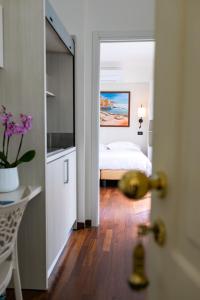 a bedroom with a bed and a view of a room at Rex Hotel Residence in Genoa