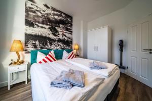 um quarto com uma cama grande e toalhas em RIAS-Beachvilla-Ocean em Borkum