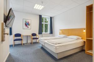 Postel nebo postele na pokoji v ubytování BB-Hotel Vejle Park
