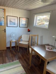 a room with a table and a chair and a window at Red cottage in Marstrand