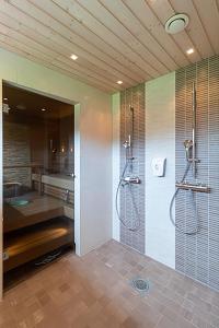 y baño con ducha y lavamanos. en Villa Luoteistuuli - 8+2 hlö, Luoteis-Himos Ski-in/out, 88m² + 30m², en Jämsä
