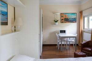 a bedroom with a table with a laptop computer on it at Rex Hotel Residence in Genoa